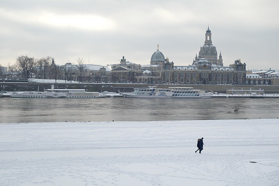 The Altstadt skyline across the snowy Elbe meadows