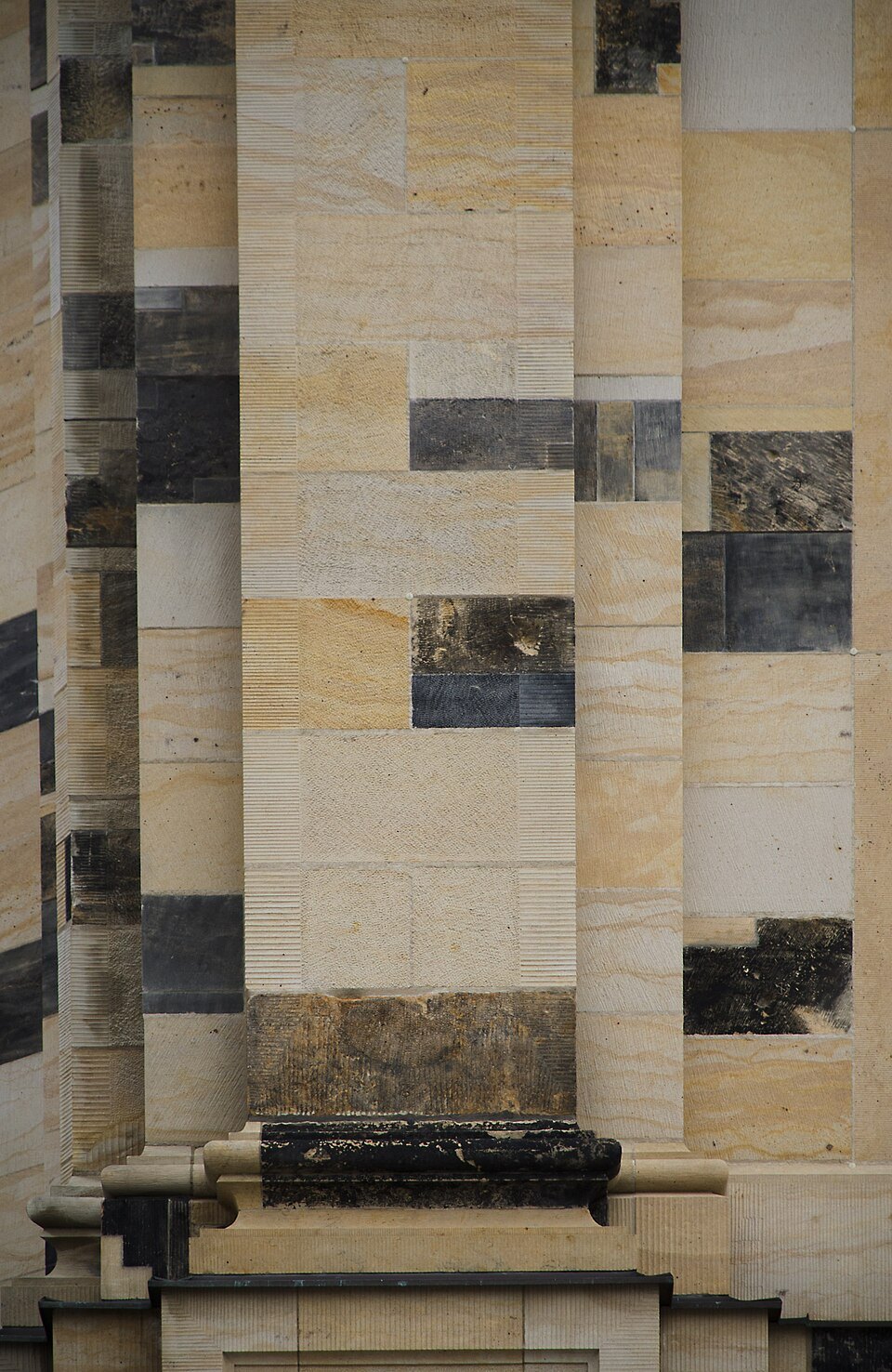 Blackened old stones set among pale new sandstone