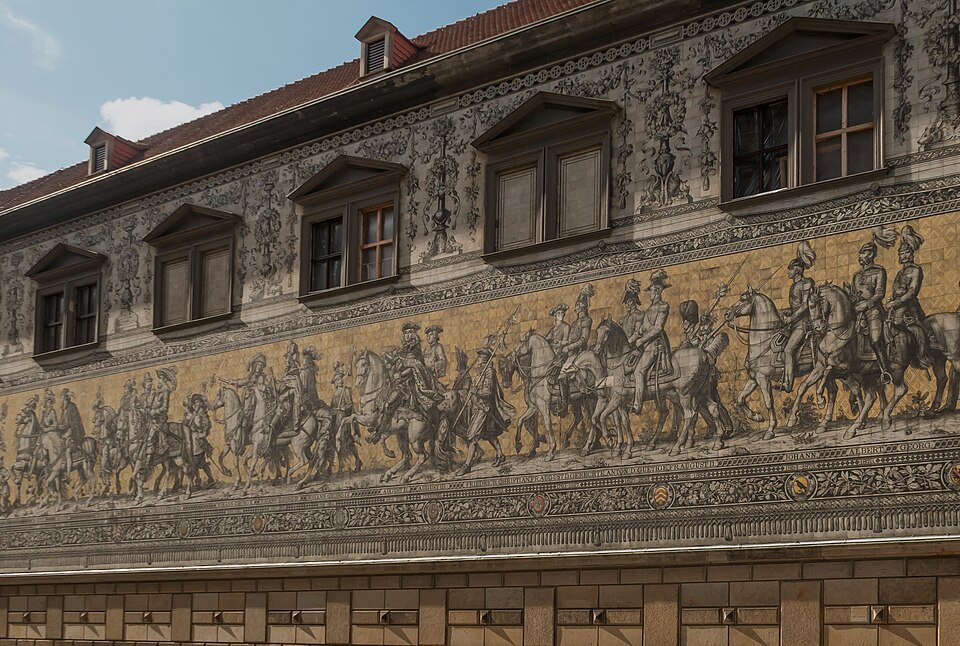 The mural's riders below a row of dormers