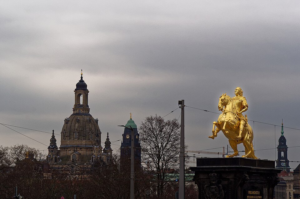 The gilded rider against the Altstadt towers