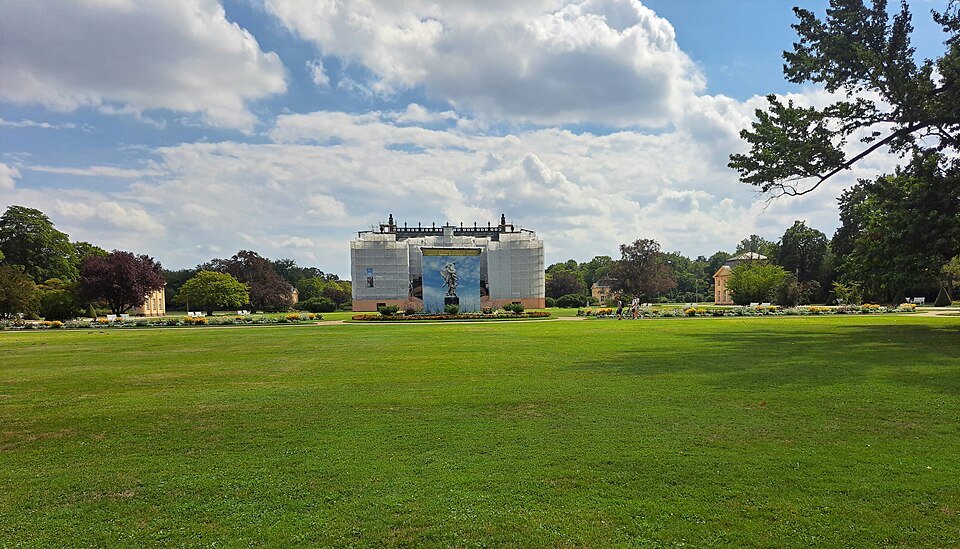 The palace under wraps beyond a wide lawn