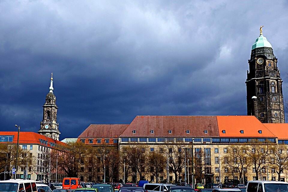 The Kreuzkirche and the Rathaus tower under a dark sky