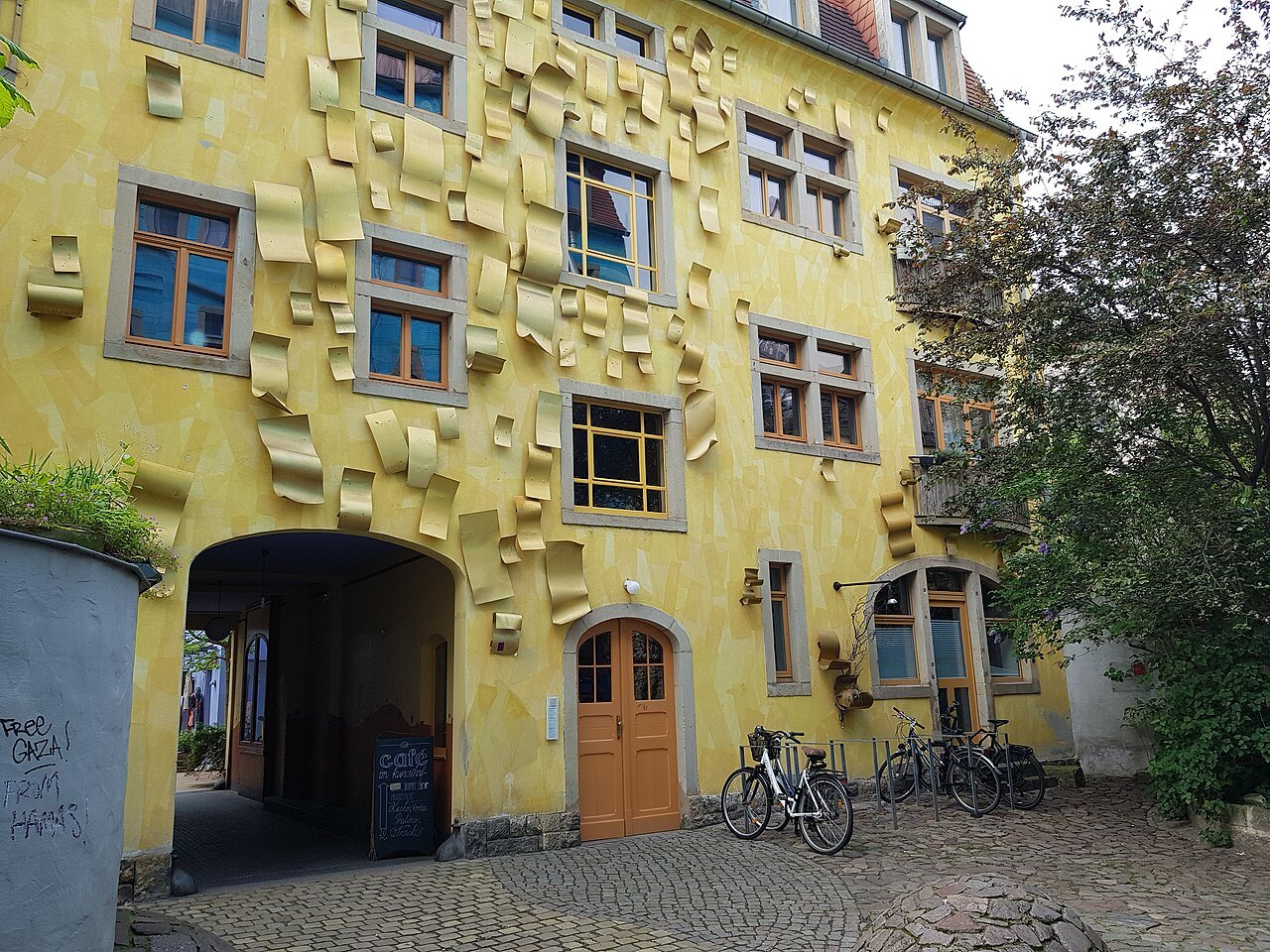 The sun-yellow wall in the Kunsthofpassage's Courtyard of the Elements