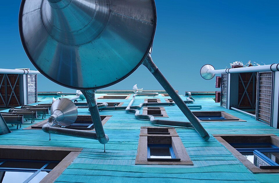 Funnels and pipes looking up the blue wall