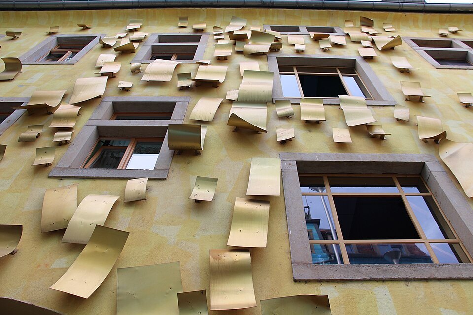 Close view of gold metal flaps around windows