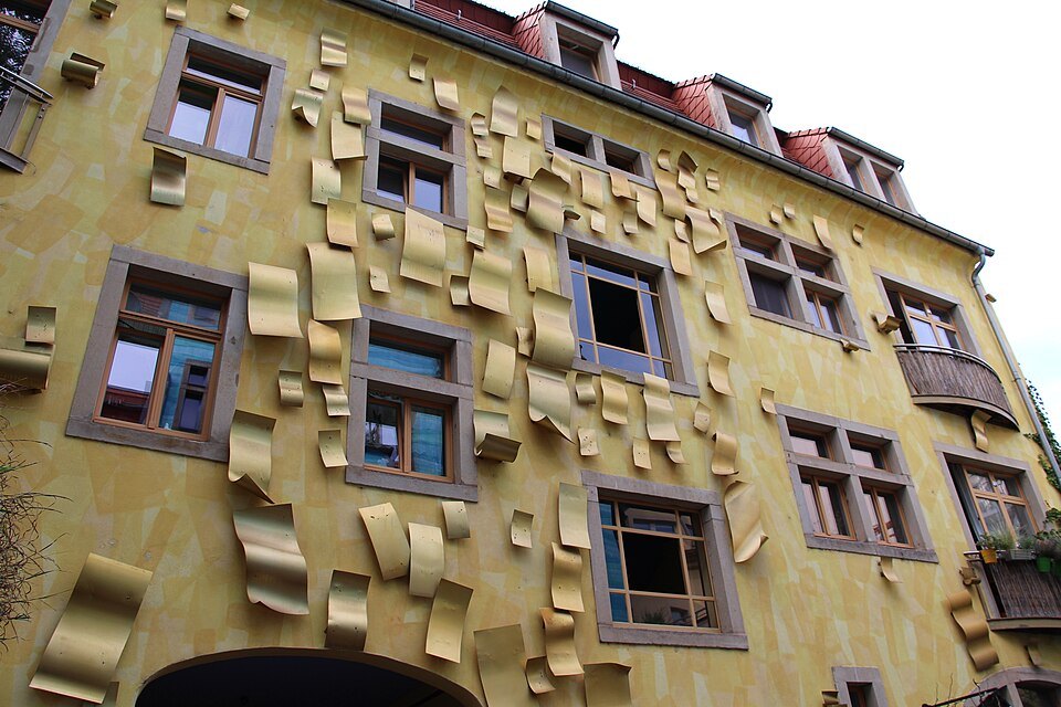 The yellow facade's metal flaps from below