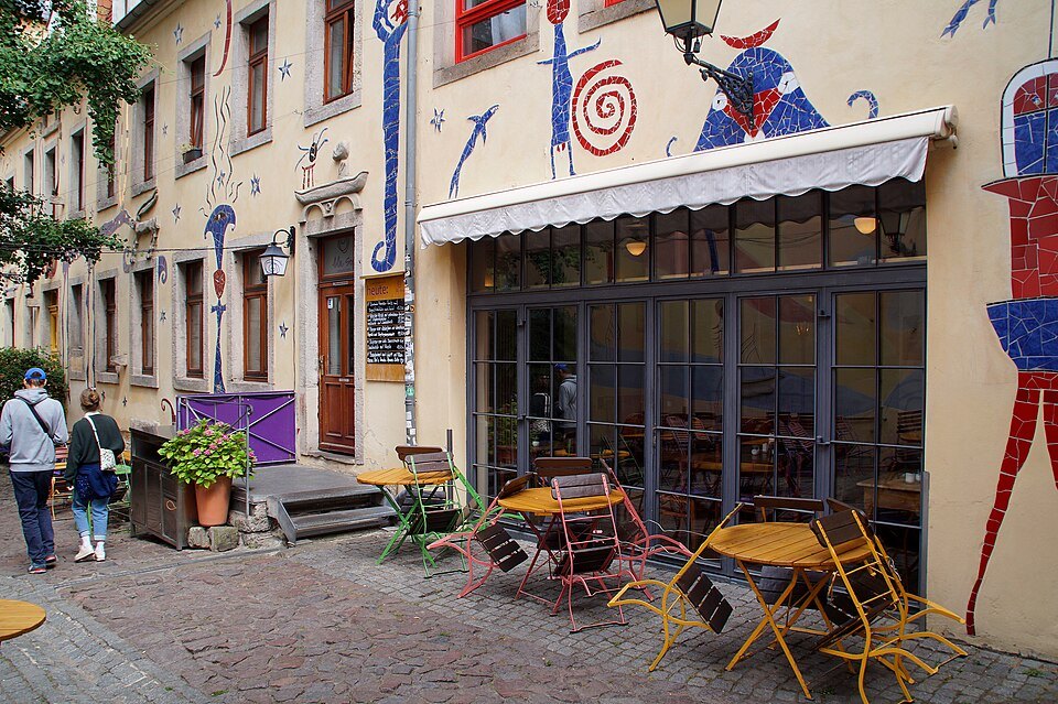 A café terrace and mosaic walls in the Kunsthofpassage