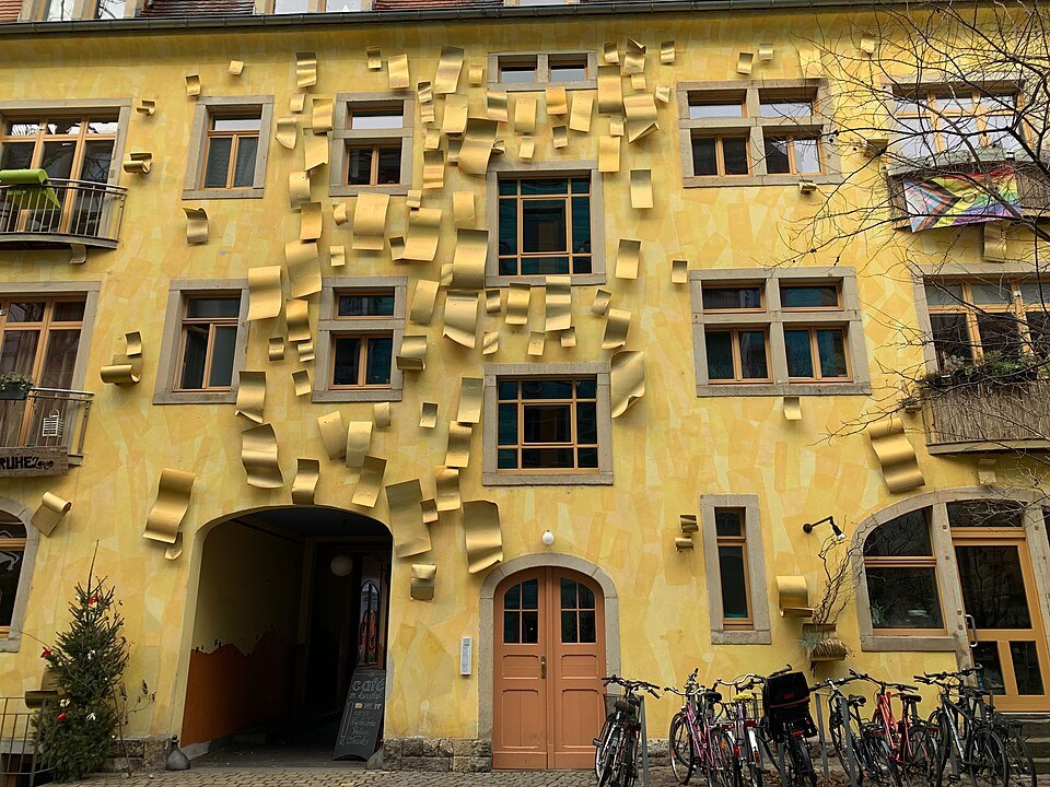 Metal flaps on a yellow Kunsthofpassage facade
