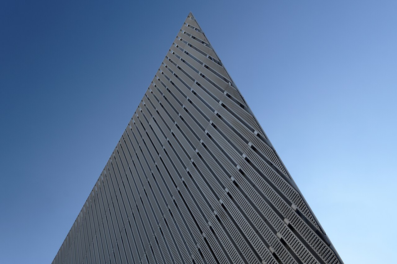 The tip of the steel wedge against the sky