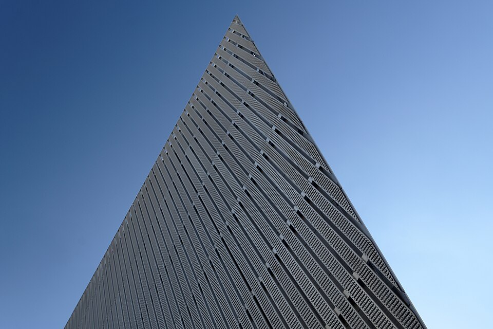 The tip of the steel wedge against the sky