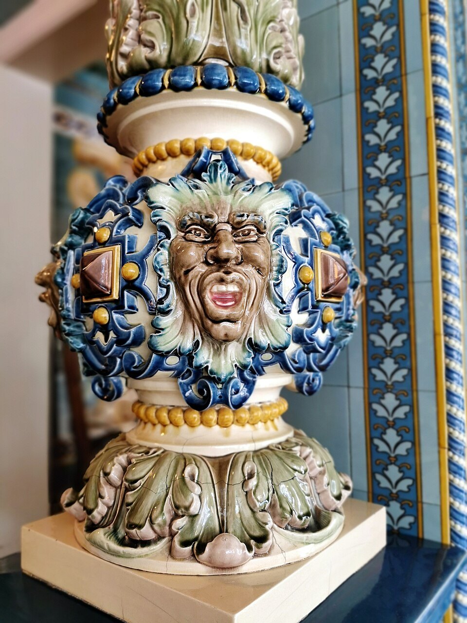 A majolica vase with a grimacing face