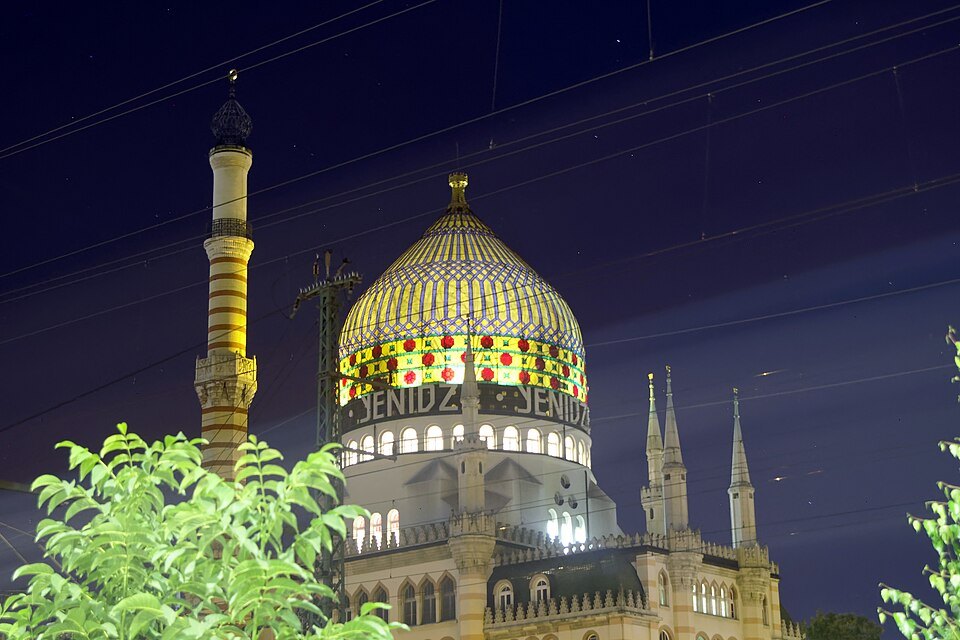 The Yenidze's glass dome lit at night